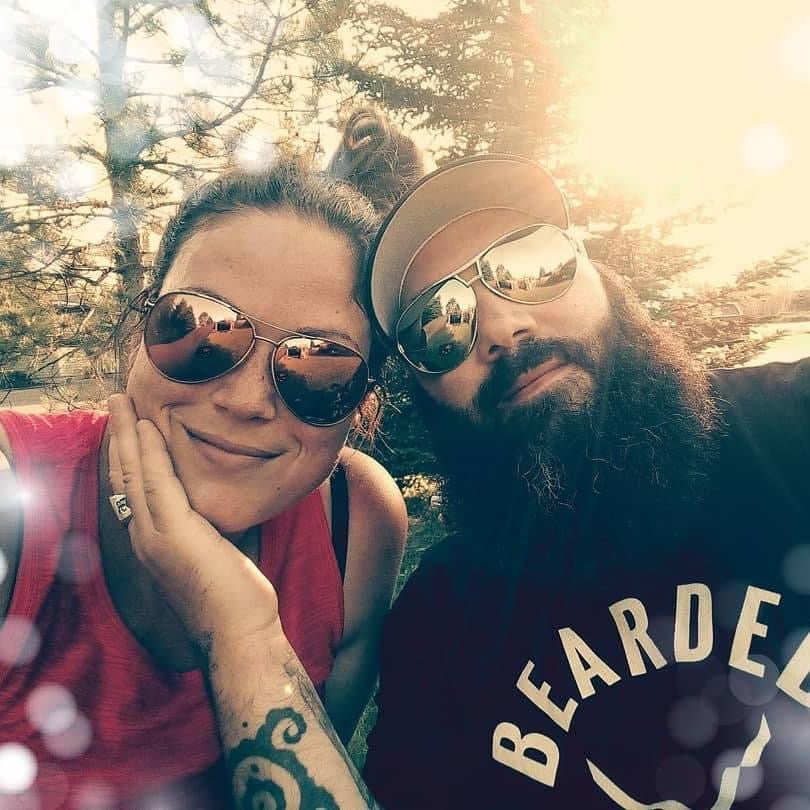 Bearded man with beautiful woman wearing sunglasses