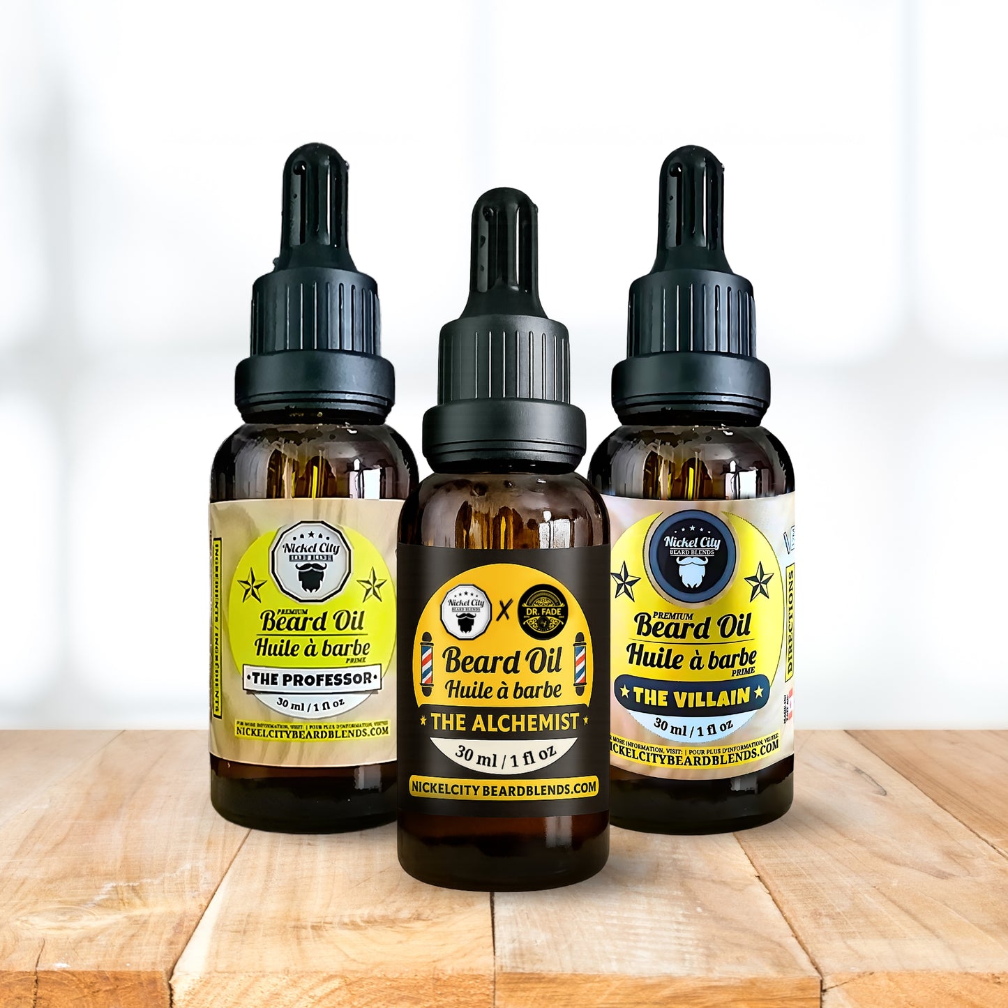 Three bottles of Nickle City Beards Blend beard oil on a wooden surface with a white background.