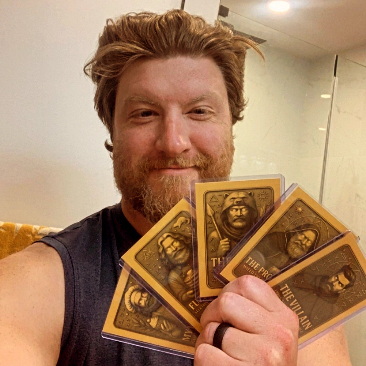 Man holding gold Soul Series collector cards with a decorative design