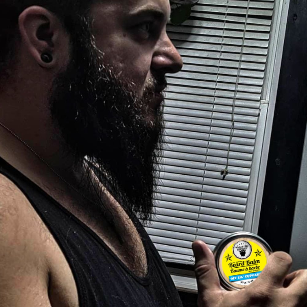 Bearded Man Holding a Beard Balm From Nickel City Beard Blends