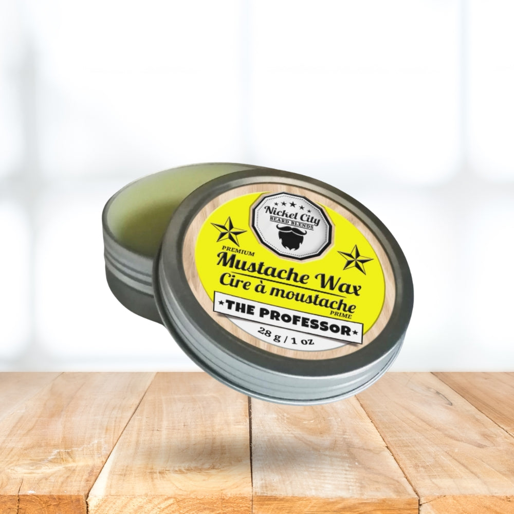 Mustache wax container with yellow label on a wooden surface