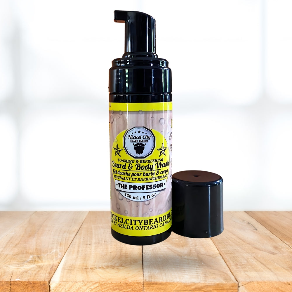 Foaming and refreshing beard and body wash bottle with yellow label on a wooden surface.