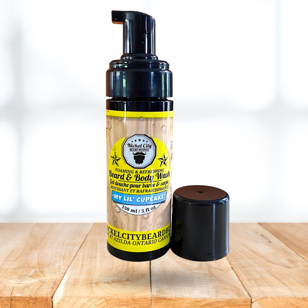 Foaming beard and body wash bottle with pump on a wooden surface