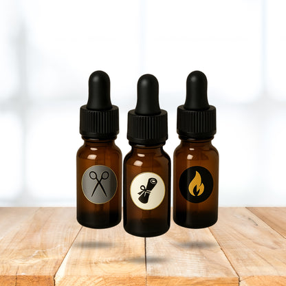 Three amber glass dropper bottles with black lids on a wooden surface.