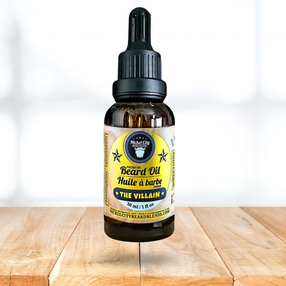 Bottle of beard oil labeled 'The Villain' on a wooden surface with a white background