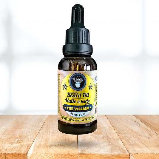Bottle of beard oil labeled 'The Villain' on a wooden surface with a white background