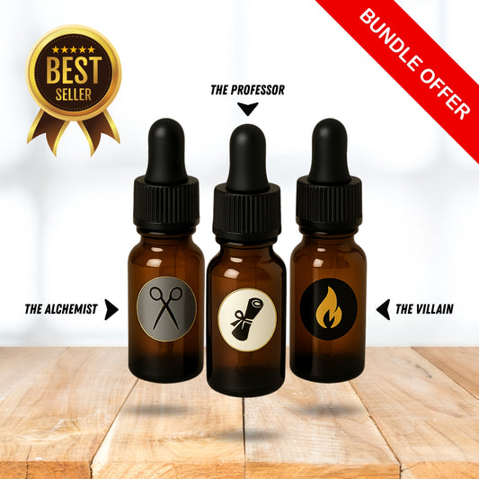 Three 5mL amber glass dropper beard oil sample-sized bottles with labels on a wooden surface, featuring 'The Alchemist', 'The Professor', and 'The Villain'.