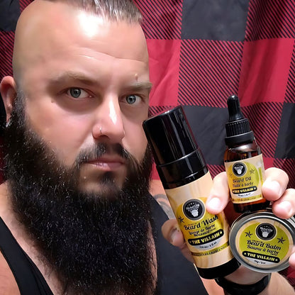 Bearded man holding beard oil, beard balm and beard wash in The Villain scent