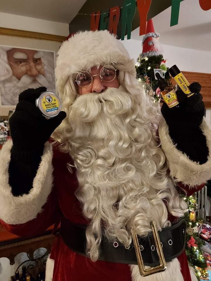 Santa Claus holding products from Nickel City Beard Blends